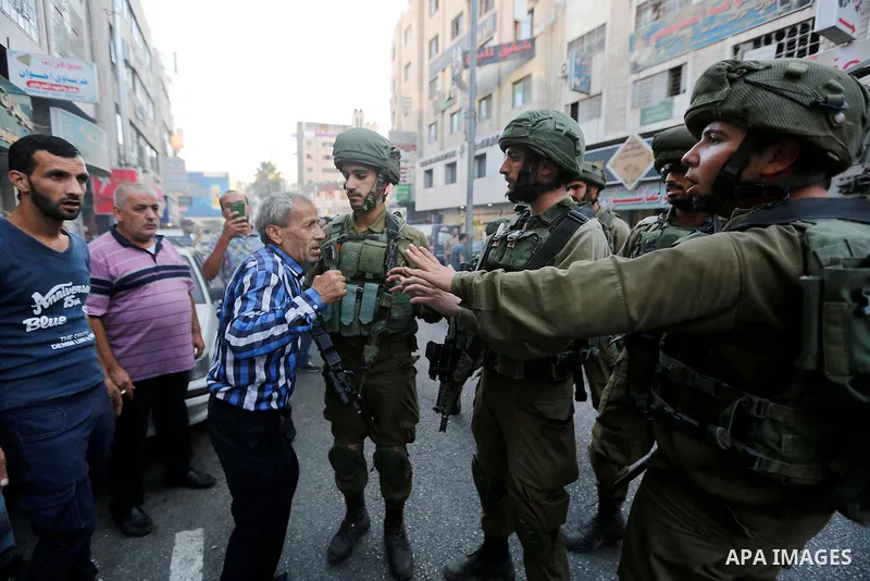 A Palestinian man argues with Israeli security forces after soldiers entered an area controlled by the Palestinian authority in the divided city of Hebron, in the Israeli-occupied West Bank, on September 20, 2017. Photo...