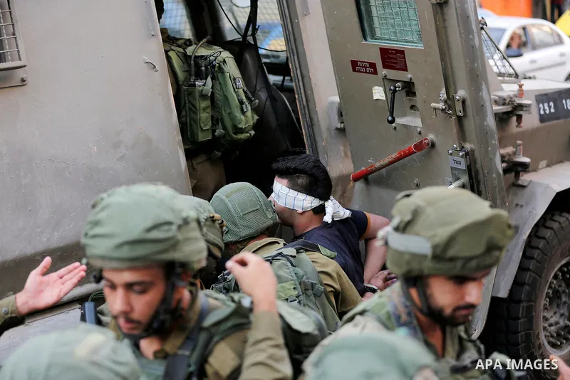 Israeli security forces detain a Palestinian youth after soldiers entered an area controlled by the Palestinian authority in the divided city of Hebron, in the Israeli-occupied West Bank, on September 20, 2017. Photo by...
