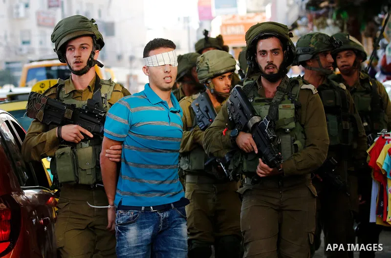 Israeli security forces detain a Palestinian youth after soldiers entered an area controlled by the Palestinian authority in the divided city of Hebron, in the Israeli-occupied West Bank, on September 20, 2017. Photo by...