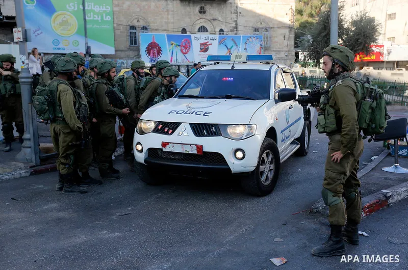 Israeli security forces take position after soldiers entered an area controlled by the Palestinian authority in the divided city of Hebron, in the Israeli-occupied West Bank, on September 20, 2017. Photo by Wisam Hashlam...