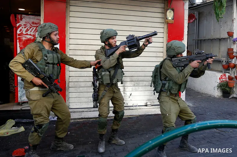 Israeli security forces take position after soldiers entered an area controlled by the Palestinian authority in the divided city of Hebron, in the Israeli-occupied West Bank, on September 20, 2017. Photo by Wisam Hashlam...