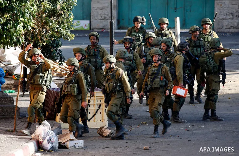 Israeli security forces take position after soldiers entered an area controlled by the Palestinian authority in the divided city of Hebron, in the Israeli-occupied West Bank, on September 20, 2017. Photo by Wisam Hashlam...