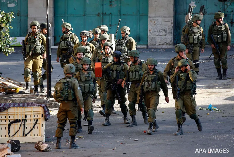 Israeli security forces take position after soldiers entered an area controlled by the Palestinian authority in the divided city of Hebron, in the Israeli-occupied West Bank, on September 20, 2017. Photo by Wisam Hashlam...