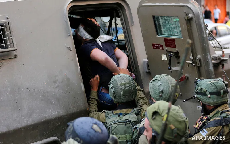 Israeli security forces detain a Palestinian youth after soldiers entered an area controlled by the Palestinian authority in the divided city of Hebron, in the Israeli-occupied West Bank, on September 20, 2017. Photo by...