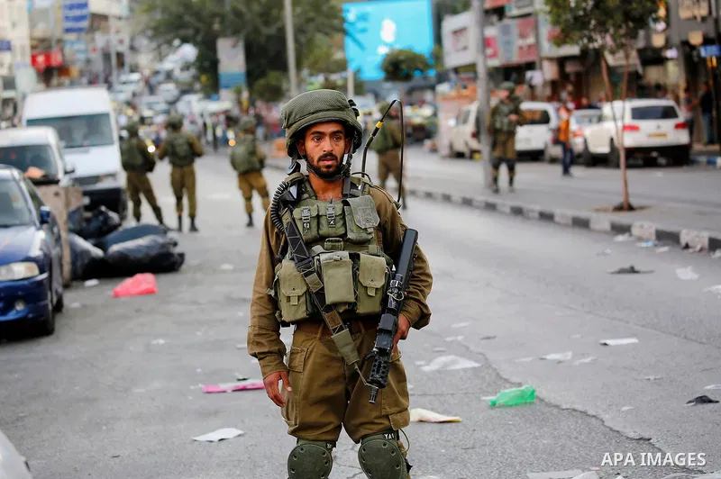 Israeli security forces take position after soldiers entered an area controlled by the Palestinian authority in the divided city of Hebron, in the Israeli-occupied West Bank, on September 20, 2017. Photo by Wisam Hashlam...