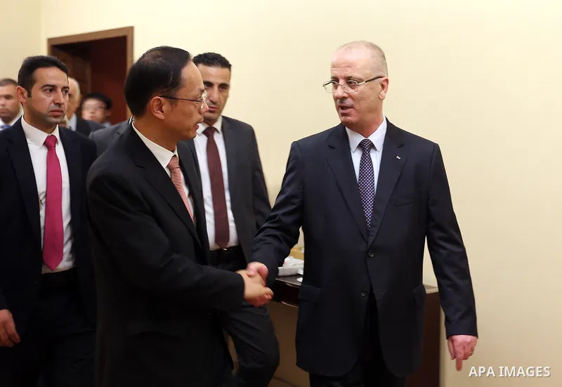 Palestinian Prime Minister Rami Hamdallah take part during the ceremony of the sixty-eighth anniversary of the founding of the People's Republic of China, in the West Bank city of Ramallah on September 20, 2017. Photo by...