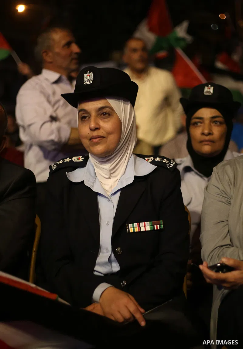 Palestinian supporters of Fateh movement watch the address of Palestinian President Mahmoud Abbas during the 72nd United Nations General Assembly at the United Nations headquarters in New York, in the West Bank city of N...