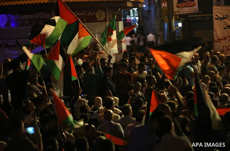 Palestinian supporters of Fateh movement watch the address of Palestinian President Mahmoud Abbas during the 72nd United Nations General Assembly at the United Nations headquarters in New York, in the West Bank city of N...