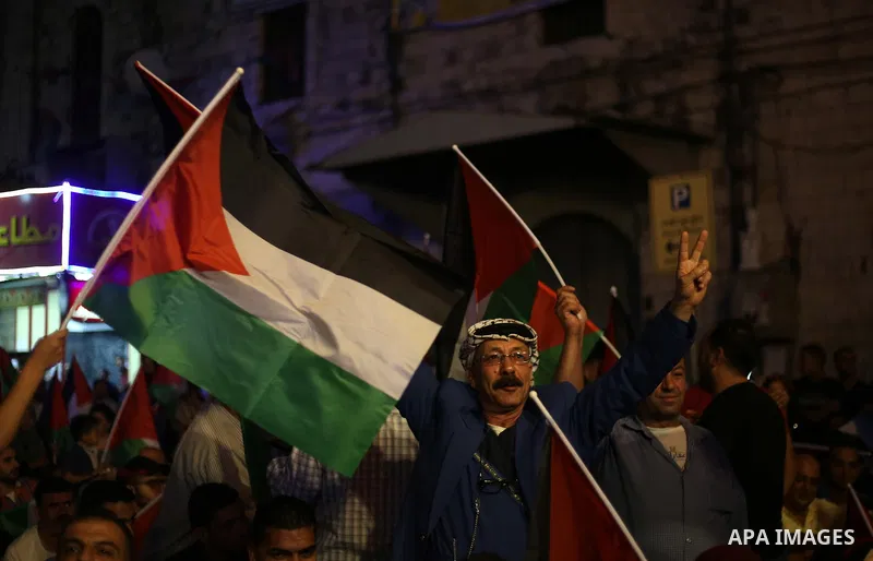 Palestinian supporters of Fateh movement watch the address of Palestinian President Mahmoud Abbas during the 72nd United Nations General Assembly at the United Nations headquarters in New York, in the West Bank city of N...