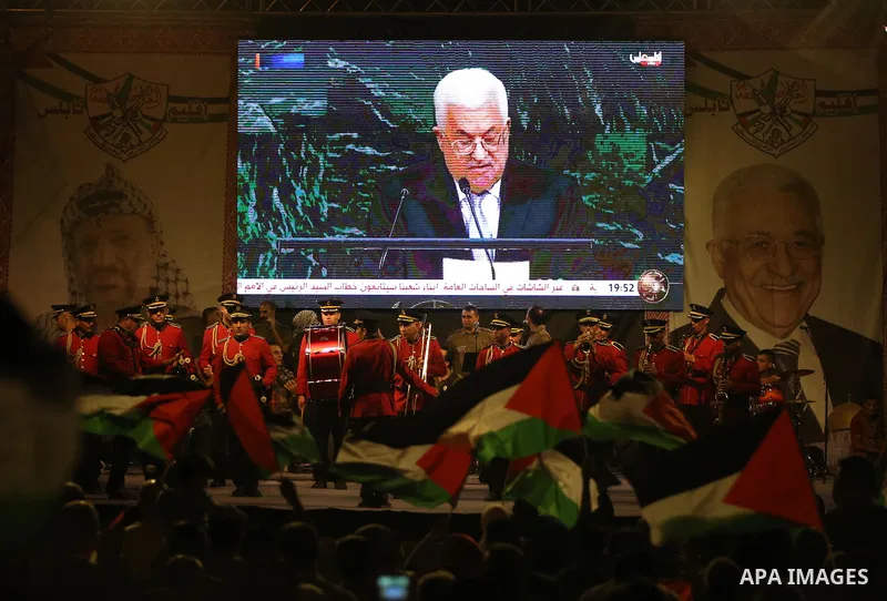 Palestinian supporters of Fateh movement watch the address of Palestinian President Mahmoud Abbas during the 72nd United Nations General Assembly at the United Nations headquarters in New York, in the West Bank city of N...