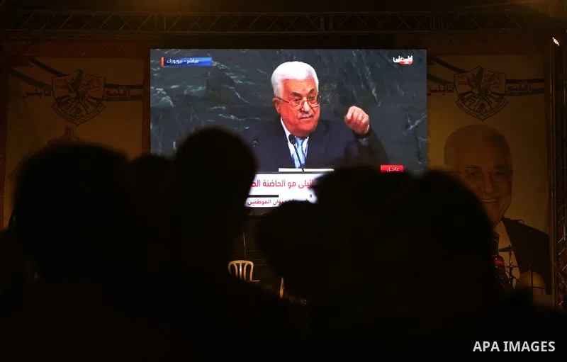 Palestinian supporters of Fateh movement watch the address of Palestinian President Mahmoud Abbas during the 72nd United Nations General Assembly at the United Nations headquarters in New York, in the West Bank city of N...