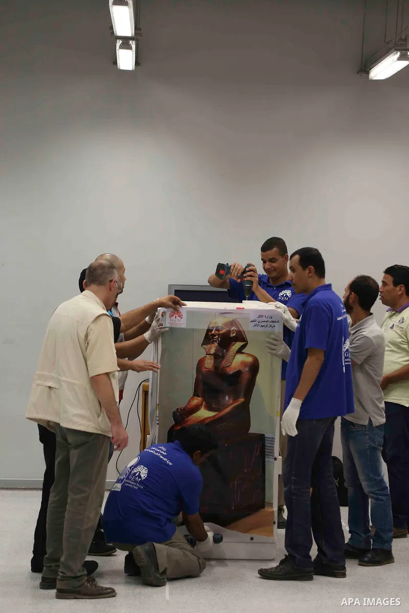 Egyptian workers transport statues upon its arrival at the restoration laboratory of the Grand Egyptian Museum (GEM) in Cairo, Egypt, on Sept. 20, 2017. A batch of statues were transported from the Egyptian Museum to the...