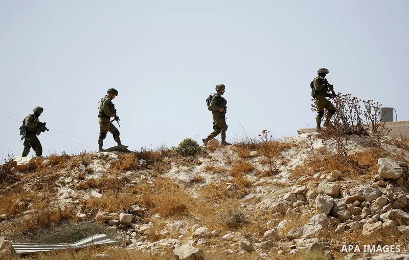 Israeli soldiers patrol during a protest by Palestinians against closure of a road south of the West Bank city of Hebron September 22, 2017. Photo by Wisam Hashlamoun
