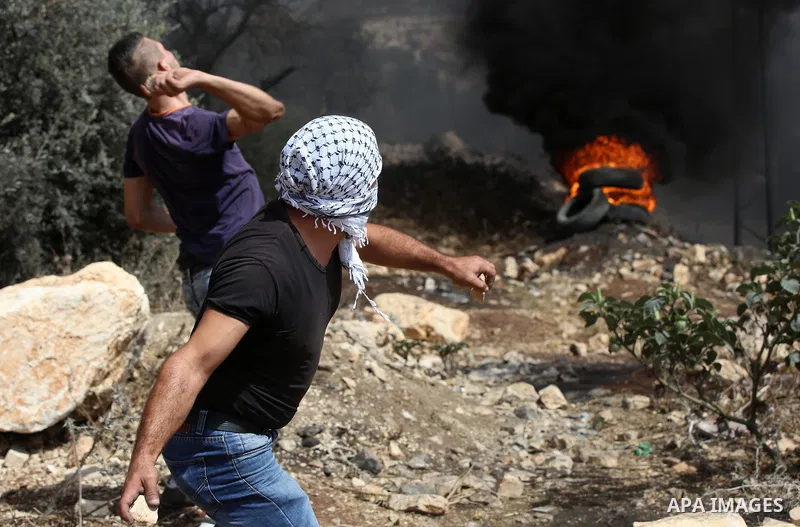 Palestinian protesters throw stones towards Israeli security forces during clashes following a demonstration against the expropriation of Palestinian land by Israel in the village of Kfar Qaddum, near Nablus in the occup...