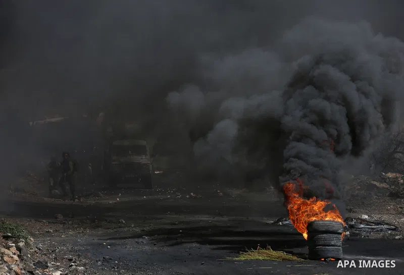 Palestinain protesters burn tires during clashes following a demonstration against the expropriation of Palestinian land by Israel in the village of Kfar Qaddum, near Nablus in the occupied West Bank, on September 22, 20...