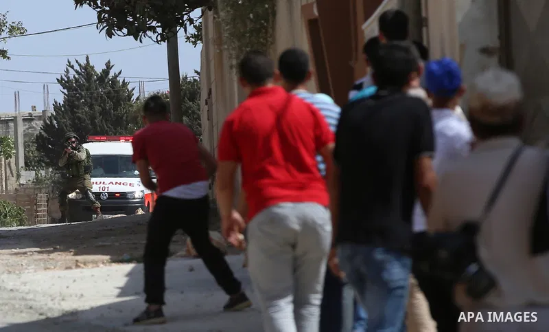 Palestinian protesters throw stones towards Israeli security forces during clashes following a demonstration against the expropriation of Palestinian land by Israel in the village of Kfar Qaddum, near Nablus in the occup...