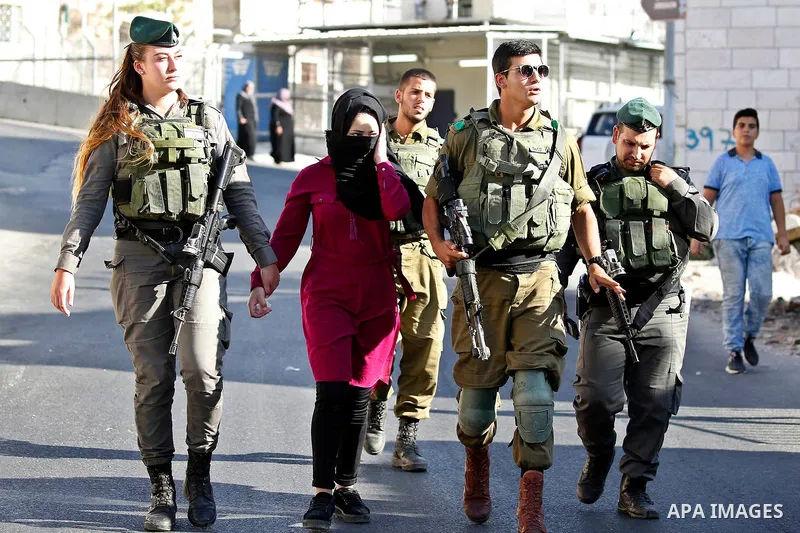 Israeli security forces detain a Palestinian girl after she allegedly tried to cross a checkpoint with a knife, near the Ibrahimi mosque, or the Tomb of the Patriarch in the West Bank city of Heborn on September 27, 2017...