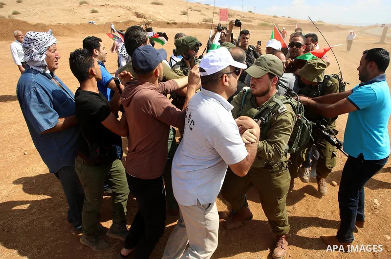 Palestinian protesters scuffle with Israeli security forces during a protest against the expropriation of Palestinian land in the village of Atouf, near the west bank city of Tubas on September 27, 2017. Photo by Ayman A...