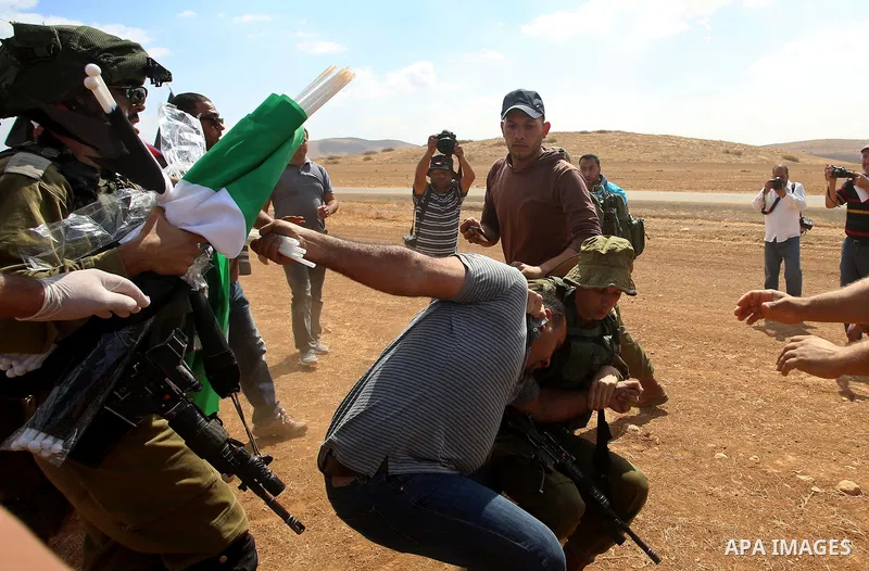 Israeli security forces detain a Palestinian protester during a protest against the expropriation of Palestinian land in the village of Atouf, near the west bank city of Tubas on September 27, 2017. Photo by Ayman Ameen