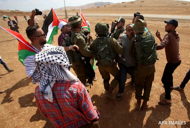 Israeli security forces detain a Palestinian protester during a protest against the expropriation of Palestinian land in the village of Atouf, near the west bank city of Tubas on September 27, 2017. Photo by Ayman Ameen