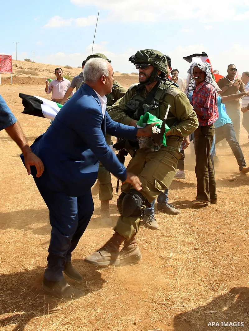 A Palestinian protester scuffles with Israeli security forces during a protest against the expropriation of Palestinian land in the village of Atouf, near the west bank city of Tubas on September 27, 2017. Photo by Ayman...