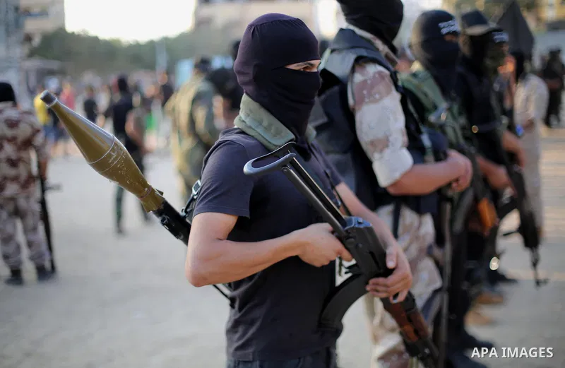 Palestinian militants from the Al-Nasser Brigades, an armed wing of the Popular Resistance Committees (PRC), take part in a military parade, in Gaza city, on September 29, 2017, to mark the 17th anniversary of the creati...