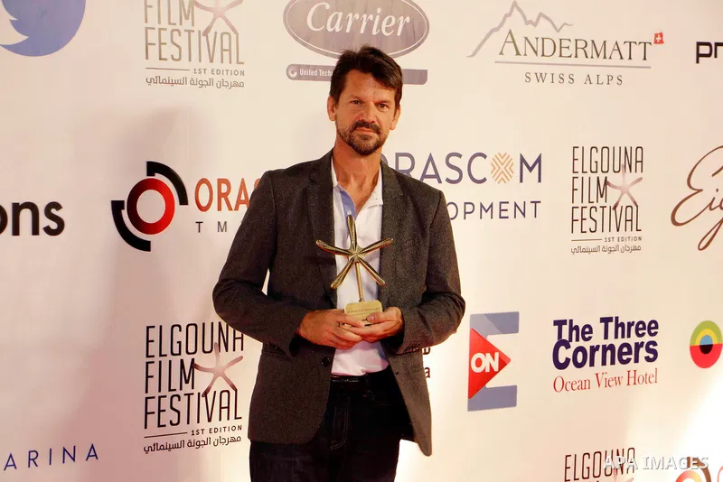 Film director Thomas Morgan poses with his audience-chosen Cinema for Humanity award for "Soufra" during the closing ceremony of the El-Gouna Film Festival, in the Red Sead resort of El-Gouna in Egypt, on September 29, 2...