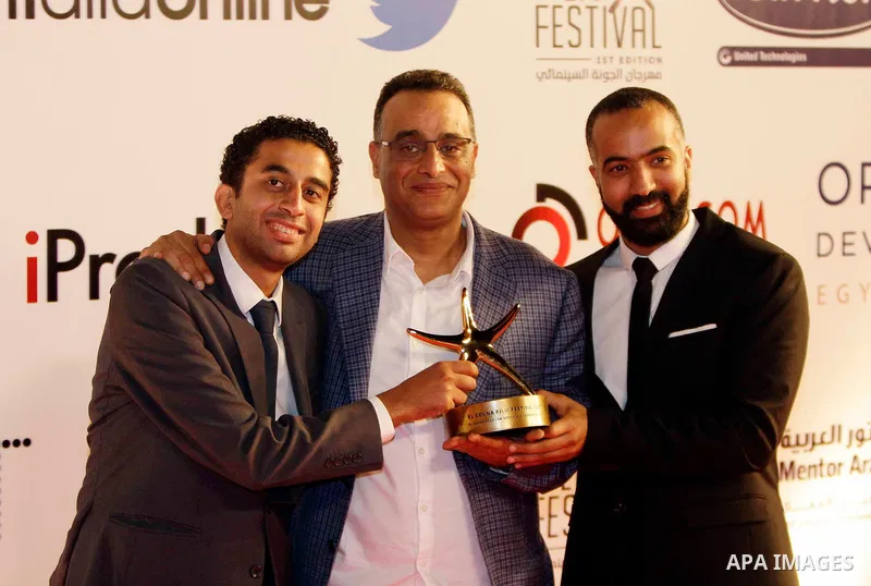 Photocopy's scriptwriter Haitham Dabbour, producer Safei Eldin Mahmoud and director Tamer Ashry pose with the Best Arab Feature Narrative award during the closing ceremony of the El-Gouna Film Festival, in the Red Sead r...