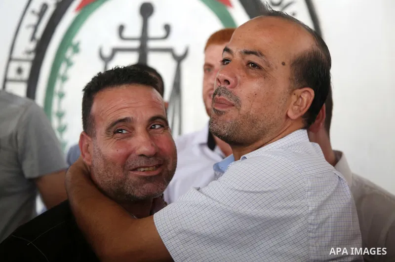 A member of the Palestinian Fatah movement, is greeted by a relative in Gaza City after his release from a Hamas-run jail as part of reconciliation efforts on October 1, 2017. Photo by Hassan Jedi