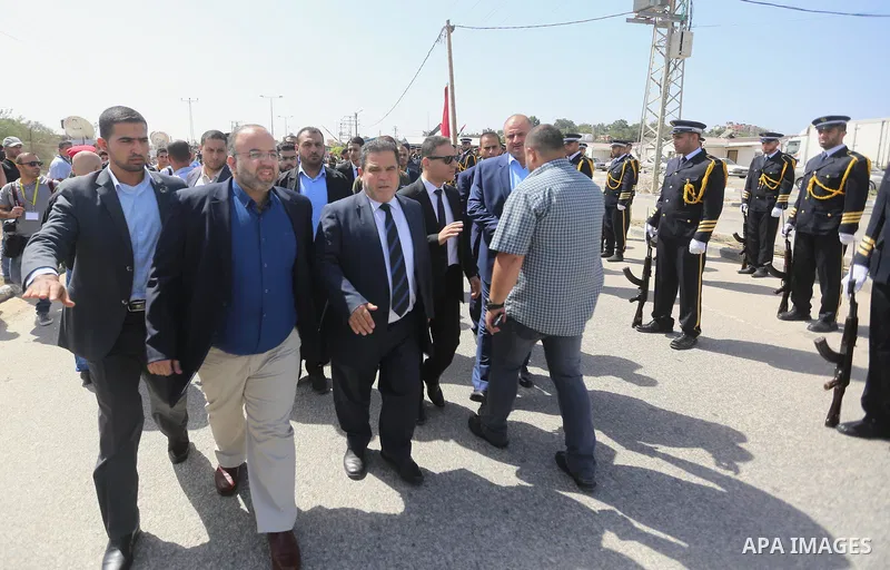 Palestinian officials wait for the arrival of Palestinian Prime Minister Rami Hamdallah and his government at Erez crossing in the northern Gaza Strip, on October 2, 2017. Hamdallah is on on his first visit to the Gaza S...