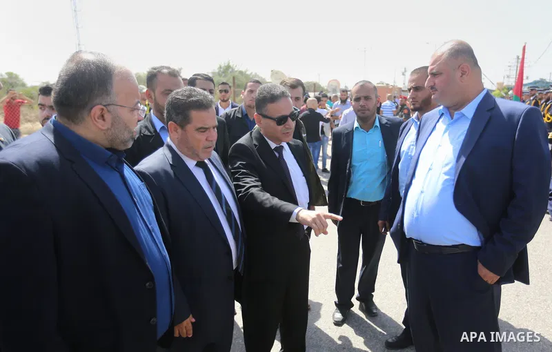Palestinian officials wait for the arrival of Palestinian Prime Minister Rami Hamdallah and his government at Erez crossing in the northern Gaza Strip, on October 2, 2017. Hamdallah is on on his first visit to the Gaza S...