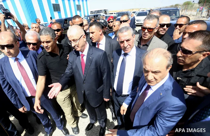 Palestinian prime minister Rami Hamdallah is surrounded by security as he arrives at the Erez border crossing in the northern Gaza Strip on October 2, 2017. Hamdallah is on on his first visit to the Gaza Strip for talks...