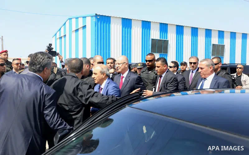 Palestinian prime minister Rami Hamdallah is surrounded by security as he arrives at the Erez border crossing in the northern Gaza Strip on October 2, 2017. Hamdallah is on on his first visit to the Gaza Strip for talks...