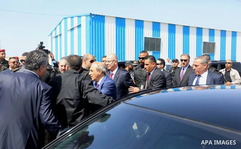 Palestinian prime minister Rami Hamdallah is surrounded by security as he arrives at the Erez border crossing in the northern Gaza Strip on October 2, 2017. Hamdallah is on on his first visit to the Gaza Strip for talks...