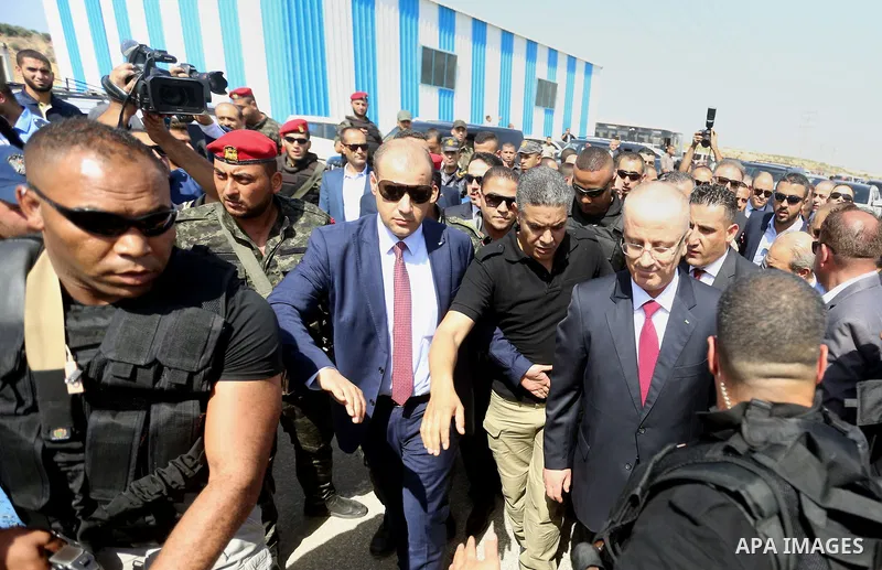 Palestinian prime minister Rami Hamdallah is surrounded by security as he arrives at the Erez border crossing in the northern Gaza Strip on October 2, 2017. Hamdallah is on on his first visit to the Gaza Strip for talks...