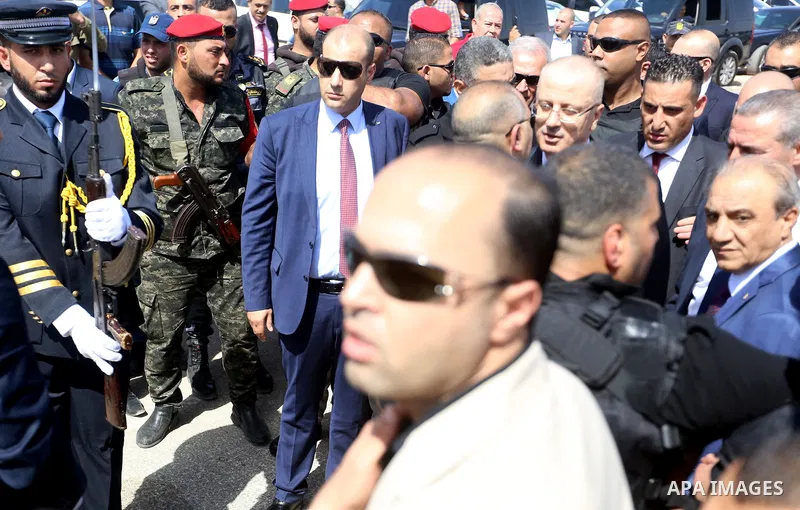 Palestinian prime minister Rami Hamdallah is surrounded by security as he arrives at the Erez border crossing in the northern Gaza Strip on October 2, 2017. Hamdallah is on on his first visit to the Gaza Strip for talks...