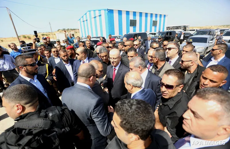 Palestinian prime minister Rami Hamdallah is surrounded by security as he arrives at the Erez border crossing in the northern Gaza Strip on October 2, 2017. Hamdallah is on on his first visit to the Gaza Strip for talks...