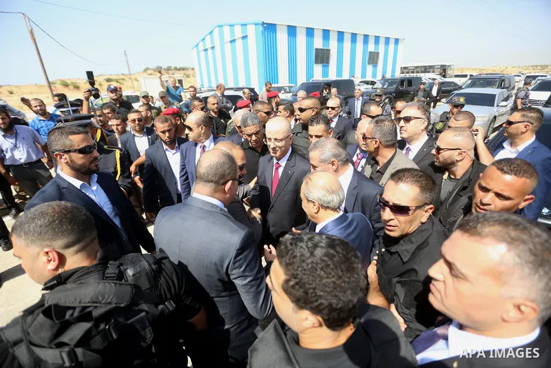Palestinian prime minister Rami Hamdallah is surrounded by security as he arrives at the Erez border crossing in the northern Gaza Strip on October 2, 2017. Hamdallah is on on his first visit to the Gaza Strip for talks...