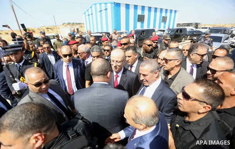 Palestinian prime minister Rami Hamdallah is surrounded by security as he arrives at the Erez border crossing in the northern Gaza Strip on October 2, 2017. Hamdallah is on on his first visit to the Gaza Strip for talks...