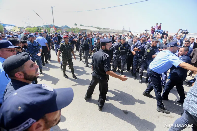 Palestinian Policemen try to hold back the crowd as the convoy of Palestinian Prime Minister Rami Hamdallah arrives to the Erez border crossing in the northern Gaza Strip on October 2, 2017. Hamdallah is on on his first...