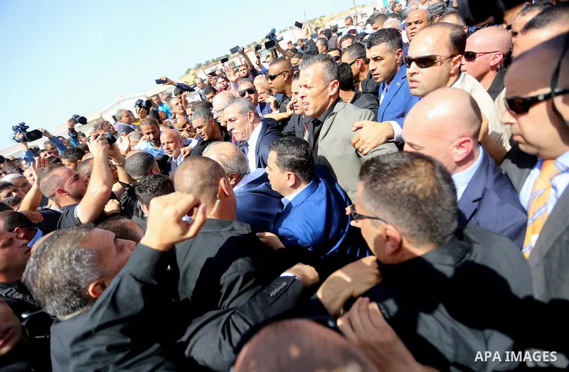 Palestinian prime minister Rami Hamdallah is surrounded by security as he arrives at the Erez border crossing in the northern Gaza Strip on October 2, 2017. Hamdallah is on on his first visit to the Gaza Strip for talks...