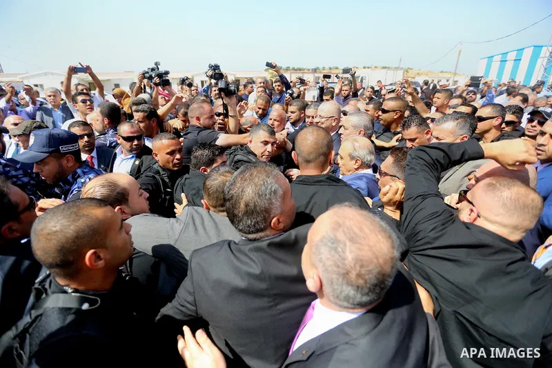 Palestinian prime minister Rami Hamdallah is surrounded by security as he arrives at the Erez border crossing in the northern Gaza Strip on October 2, 2017. Hamdallah is on on his first visit to the Gaza Strip for talks...