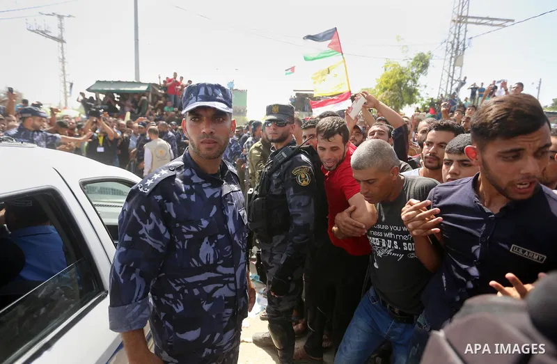 Palestinians celebrate as the convoy of Palestinian Prime Minister Rami Hamdallah and his government ministers arrive to the Erez border crossing in the northern Gaza Strip on October 2, 2017. Hamdallah is on on his firs...