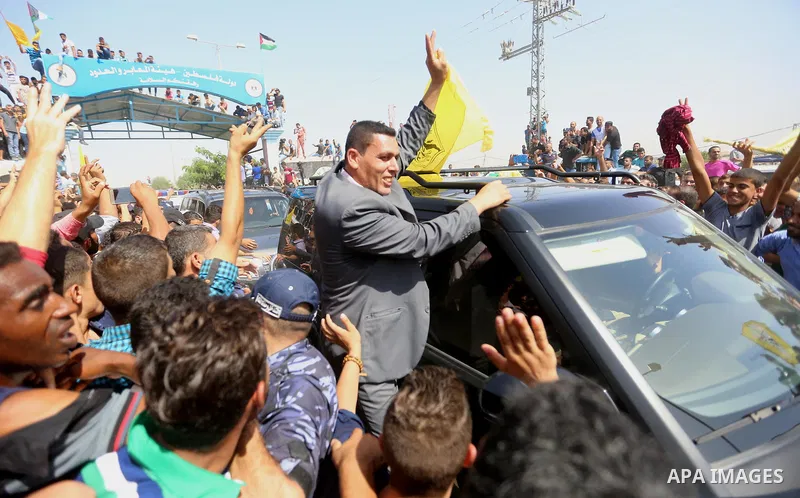 Palestinians celebrate as the convoy of Palestinian Prime Minister Rami Hamdallah and his government ministers arrive to the Erez border crossing in the northern Gaza Strip on October 2, 2017. Hamdallah is on on his firs...