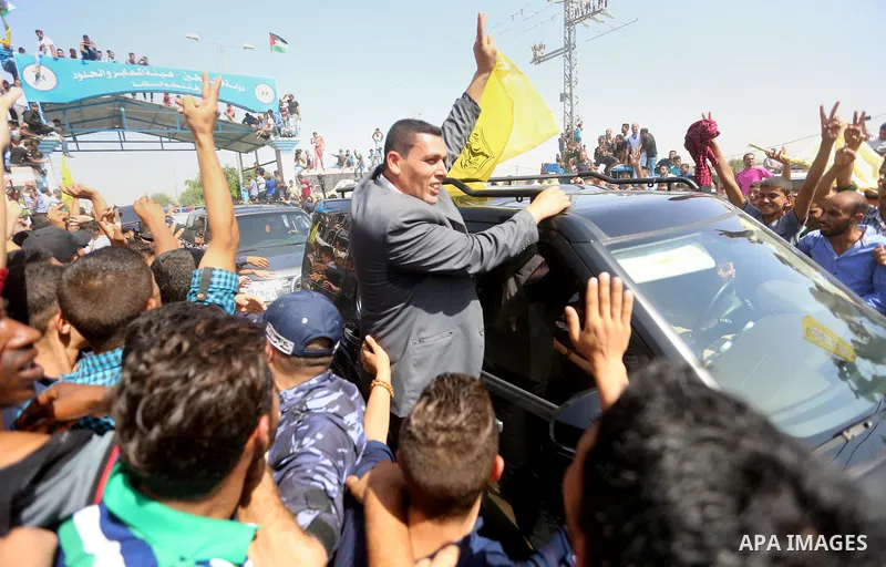 Palestinians celebrate as the convoy of Palestinian Prime Minister Rami Hamdallah and his government ministers arrive to the Erez border crossing in the northern Gaza Strip on October 2, 2017. Hamdallah is on on his firs...