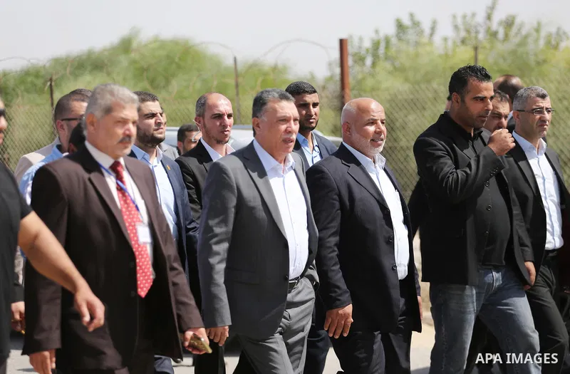 Ahmed Hilles, top Fatah official in Gaza and Tawfiq Abu Naim Undersecretary of the Ministry of Interior in Gaza wait for the arrival of Palestinian Prime Minister Rami Hamdallah and his government at Erez crossing in the...