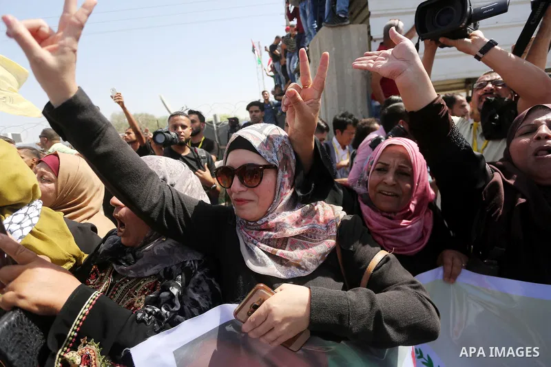 Palestinians gather at the Erez border crossing as Palestinian Prime Minister Rami Hamdallah's convoy arrives in the northern Gaza Strip on October 2, 2017. Hamdallah is on on his first visit to the Gaza Strip for talks...