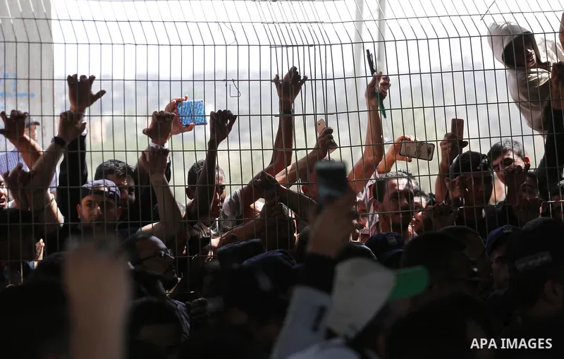 Palestinians gather at the Erez border crossing as Palestinian Prime Minister Rami Hamdallah's convoy arrives in the northern Gaza Strip on October 2, 2017. Hamdallah is on on his first visit to the Gaza Strip for talks...
