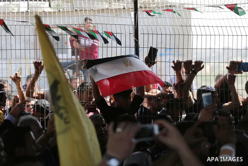 Palestinians gather at the Erez border crossing as Palestinian Prime Minister Rami Hamdallah's convoy arrives in the northern Gaza Strip on October 2, 2017. Hamdallah is on on his first visit to the Gaza Strip for talks...
