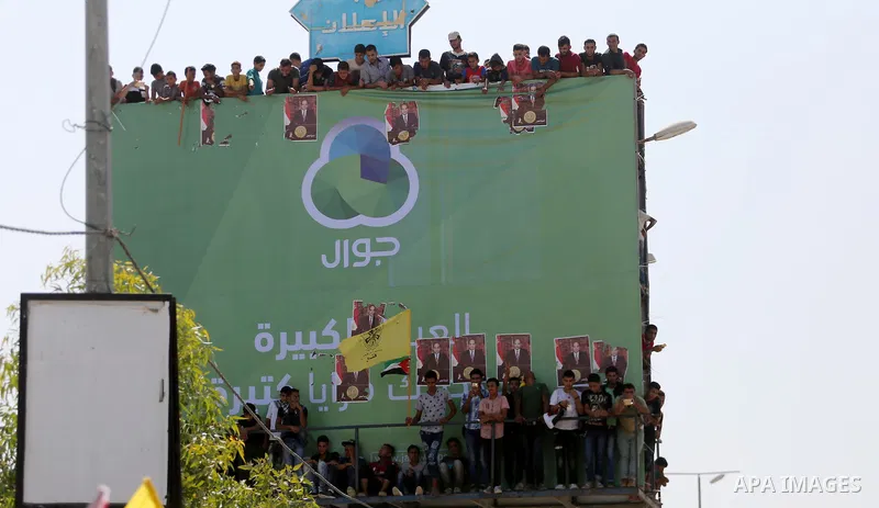 Palestinians gather at the Erez border crossing as Palestinian Prime Minister Rami Hamdallah's convoy arrives in the northern Gaza Strip on October 2, 2017. Hamdallah is on on his first visit to the Gaza Strip for talks...